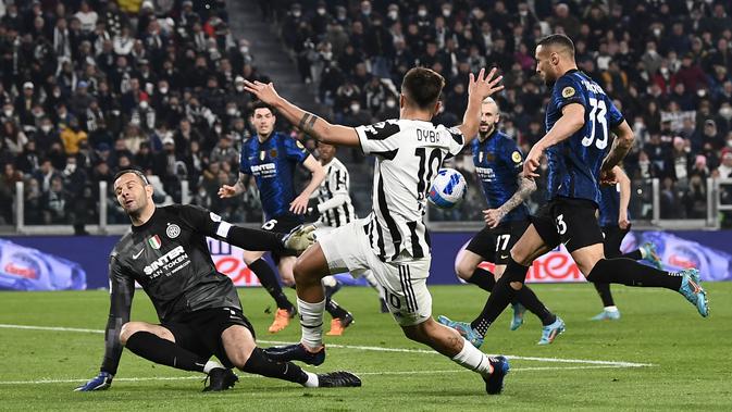 Paulo Dybala dari Juventus dan Samir Handanovic dari Inter Milan berebut bola dalam pertandingan sepak bola Serie A antara Juventus dan Inter Milan, di stadion Allianz di Turin, Italia, Minggu, 3 April 2022. (Fabio Ferrari/LaPresse via AP)