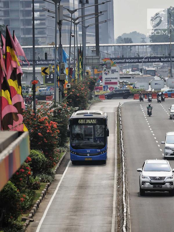 Bus Transjakarta melintas di kawasan Sudirman, Jakarta, Rabu (11/7). Pemprov DKI menyiapkan 1.500 bus Transjakarta untuk mendukung mobilitas warga, atlet, offisial, hingga jurnalis peliput pertandingan Asian Games di Jakarta. (Liputan6.com/Faizal Fanani)
