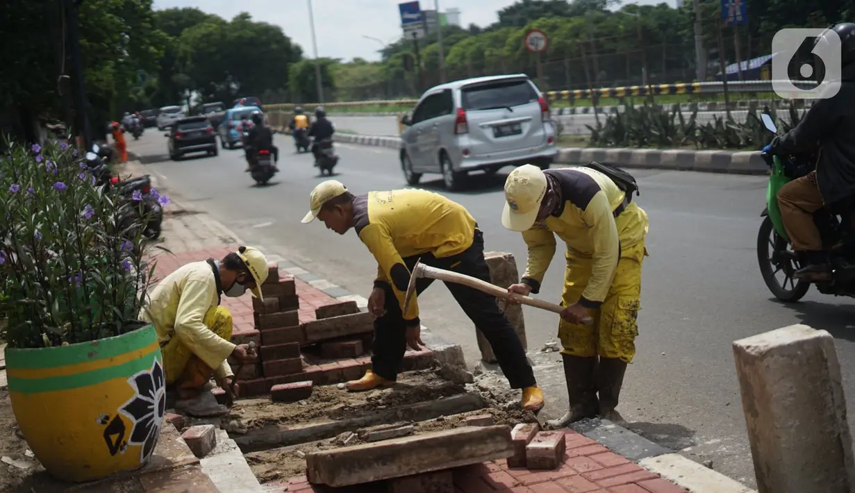 Petugas Bina Marga memerlebar saluran air di Jalan TB Simatupang di kawasan Cilandak, Jakarta, Kamis (22/10/2020). Hal tersebut dilakukan guna memaksimalkan fungsi sistem drainase agar tidak terjadi genangan air saat menghadapi musim hujan. (Liputan6.com/Immanuel Antonius)