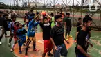 Anak-anak berlatih sepak bola di lapangan samping Banjir Kanal Barat (BKB), Jakarta, Kamis (7/1/2020). Revitalisasi jalur hijau di sepanjang aliran BKB menyulap kawasan kumuh menjadi tempat interaktif warga sekitar yang dilengkapi fasilitas bermain, seperti lapangan futsal. (Liputan6.com/Johan Tallo