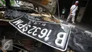 Plat nomor yang berada diatas bangkai mobil yang hangus akibat terbakar di Pecenongan, Jakarta, Sabtu (11/2). Berdasarkan saksi mata yang berada di seberang jalan lokasi, ia melihat ada dua motor berboncengan empat orang. (Liputan6.com/Immanuel Antonius)