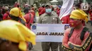 Petugas Satpol PP memegang poster imbauan protokol kesehatan COVID-19 saat unjuk rasa buruh di depan Gedung DPR, Jakarta, Selasa (17/11/2020). Pemerintah terus mengingatkan pentingnya 3M yaitu memakai masker, menjaga jarak, dan mencuci sebagai upaya pencegahan Covid-19. (Liputan6.com/Faizal Fanani)