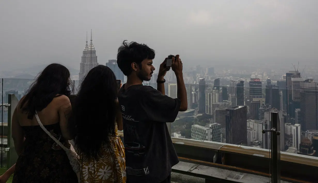 Pengunjung mengambil foto dari Menara KL saat kota Kuala Lumpur diselimuti kabut asap,  Selasa, 11 Agustus 2026/ (AFP/ Mohd Rasfan).