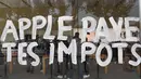 Tulisan "Apple membayar pajak anda"  tertulis di jendela toko Apple saat peluncuran iPhone X di Aix-en- Provence, Prancis (3/11). Unjuk rasa ini menentang penghindaran pajak oleh Apple. (AFP Photo/Anne-Christine Poujoulat)