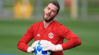 Kiper Manchester United, David De Gea, menangkap bola saat latihan di Kompleks Carrington, Manchester, Selasa (2/10/2018). Latihan ini persiapan jelang laga Liga Champions melawan Valencia. (AFP/Lindsey Parnaby)