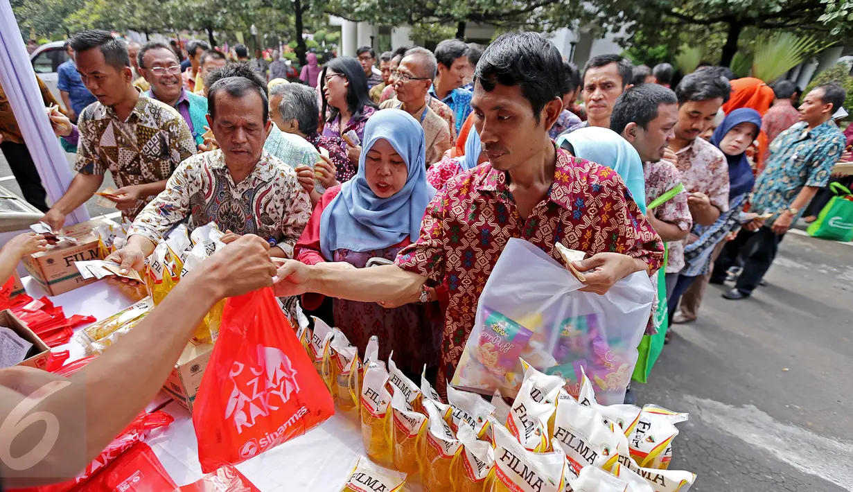 Pegawai antri untuk membeli minyak goreng murah Bazar Rakyat di lapangan parkir Kementerian Luar Negeri, Jakarta.(19/08). Bazar berlangsung bertepatan dengan ulang tahun Kementerian Luar Negeri ke-71. (Liputan6.com/Angga Yuniar)