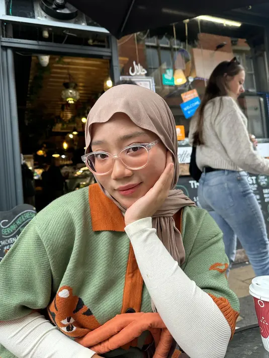 <p>penampilan Zara saat berada di sebuah kafe. Dia mengenakan atasan berwarna hijau yang dipadukan dengan pasmina krem. (Foto: Instagram/ camilliazr)</p>