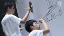 Penyandang disabilitas tampak serius saat melukis mural di kanvas sepanjang 20 meter di Balai Kota DKI Jakarta, Kamis (11/10). Kegiatan tersebut diadakan sebagai sarana untuk para penyandang disabilitas berkarya. (Liputan6.com/Immanuel Antonius)