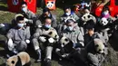 Peneliti menggendong sepuluh bayi panda yang lahir selama tahun 2020 di Pusat Penelitian dan Konservasi China untuk Panda Raksasa di Cagar Alam Wolong, Provinsi Sichuan, China, 3 Februari 2021. Sepuluh bayi panda memulai debutnya menjelang Tahun Baru Imlek di Cagar Alam Wolong. (Chinatopix via AP)