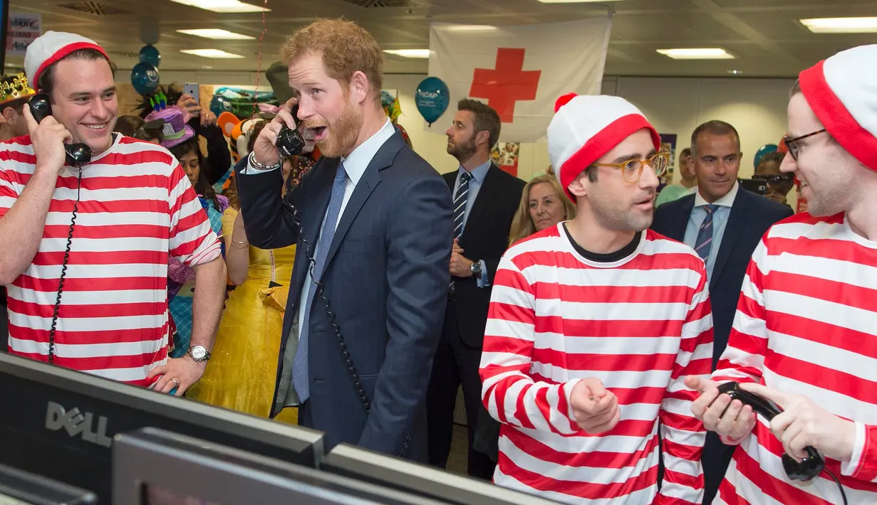 Ekspresi lucu Pangeran Harry saat ambil bagian menjadi broker dalam acara amal tahunan ICAP di London, Rabu (7/12). Pangeran Harry menjadi broker dadakan untuk mengumpulkan dana amal dari 60 kantor di seluruh dunia. (REUTERS/Geoff Pugh/Pool)