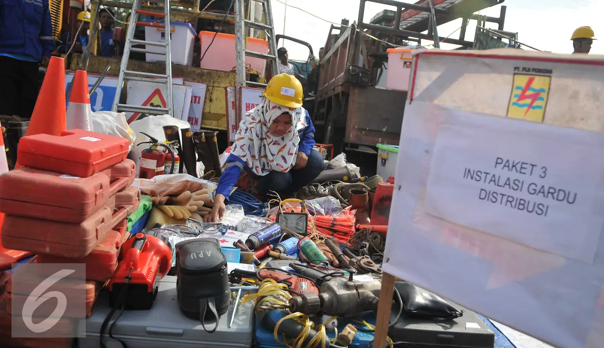 Petugas PLN memeriksa peralatan kerja di Pacuan Kuda Pulomas, Jakarta (27/4). Jenis pekerjaan mitra PLN terdiri dari Pekerjaan JTM, JTR, Instalasi Gardu, serta Sambungan Rumah dan Alat Pembatas dan Alat Pengukur (SR-APP). (Liputan6.com/Gempur M Surya)