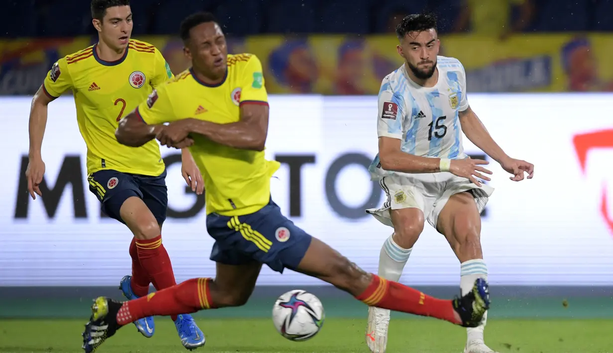 Gelandang timnas Argentina, Nicolas Gonzalez dan bek Kolombia, Yerry Mina (tengah) berebut bola pada laga lanjutan Kualifikasi Piala Dunia 2022 Zona Amerika Selatan di Stadion Metropolitano, Rabu (9/6/2021) pagi WIB. Argentina harus puas bermain imbang 2-2 dengan Kolombia. (Raul ARBOLED/AFP)