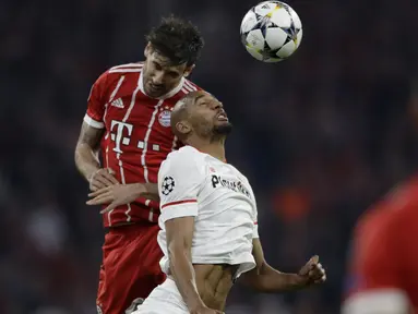 Pemain Bayern,  Javi Martinez (kiri) melakukan duel dengan pemain Sevilla, Steven N'Zonzi pada leg kedua perempat final Liga Champions di Allianz Arena stadium, Munich, (11/4/2018). Bayern lolos ke semifinal dengan agregat 2-1. (AP/Matthias Schrader)