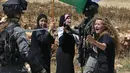 Foto yang diambil pada 26 Mei 2017 menunjukkan Ahed Tamimi (kanan) melakukan protes di depan pasukan Israel di Desa Nabi Saleh. Ahed Tamimi adalah gadis Palestina yang viral karena keberaniannya melawan tentara Israel. (AFP Photo/Abbas Momani)