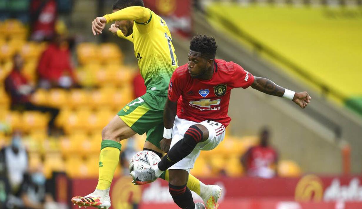 Gelandang Manchester United, Fred, berebut bola dengan pemain Norwich City, Emi Buendia, pada laga Piala FA di Carrow Road, Norwich, Sabtu (27/6/2020). Manchester United menang 2-1 atas Norwich City. (AP/Emi Buendia)