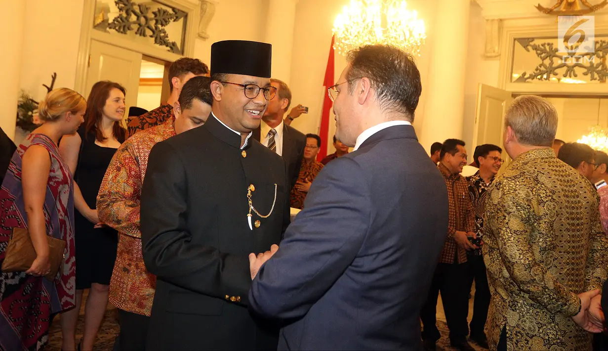 Gubernur DKI Jakarta Anies Baswedan (kiri) menyalami tamu undangan dalam Malam Resepsi HUT ke-491 Kota Jakarta di Balai Kota Jakarta, Jumat (22/6). Acara tersebut dihadiri oleh para duta besar negara dan sejumlah tokoh. (Liputan6.com/JohanTallo)