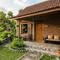 Contoh Rumah Desa dengan Teras Keramik Motif Batu dan Taman Mini (created by AI)