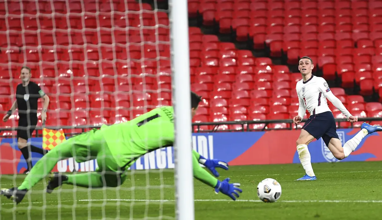 Penjaga gawang Polandia Wojciech Szczesny menghalau tendangan pemain Inggris Phil Foden (kanan) pada pertandingan Grup I kualifikasi Piala Dunia 2022 di Stadion Wembley, London, Inggris, Rabu (31/3/2021). Inggris menang dengan skor 2-1. (Andy Rain/Pool via AP)