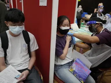 Seorang siswa sekolah menengah menerima dosis vaksin Pfizer terhadap penyakit coronavirus (COVID-19) di pusat vaksin di Shah Alam, Malaysia, Senin (20/9/2021). (AP Photo/Vincent Thian)