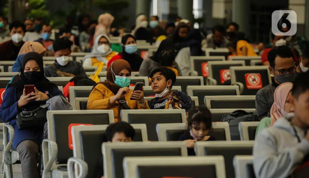 Calon penumpang bersama anaknya menunggu di Stasiun Senen, Jakarta, Sabtu (23/10/2021). PT Kereta Api Indonesia (Persero) kembali memperbolehkan anak-anak usia di bawah 12 tahun naik KA Jarak jauh mulai 22 Oktober 2021. (Liputan6.com/Faizal Fanani)