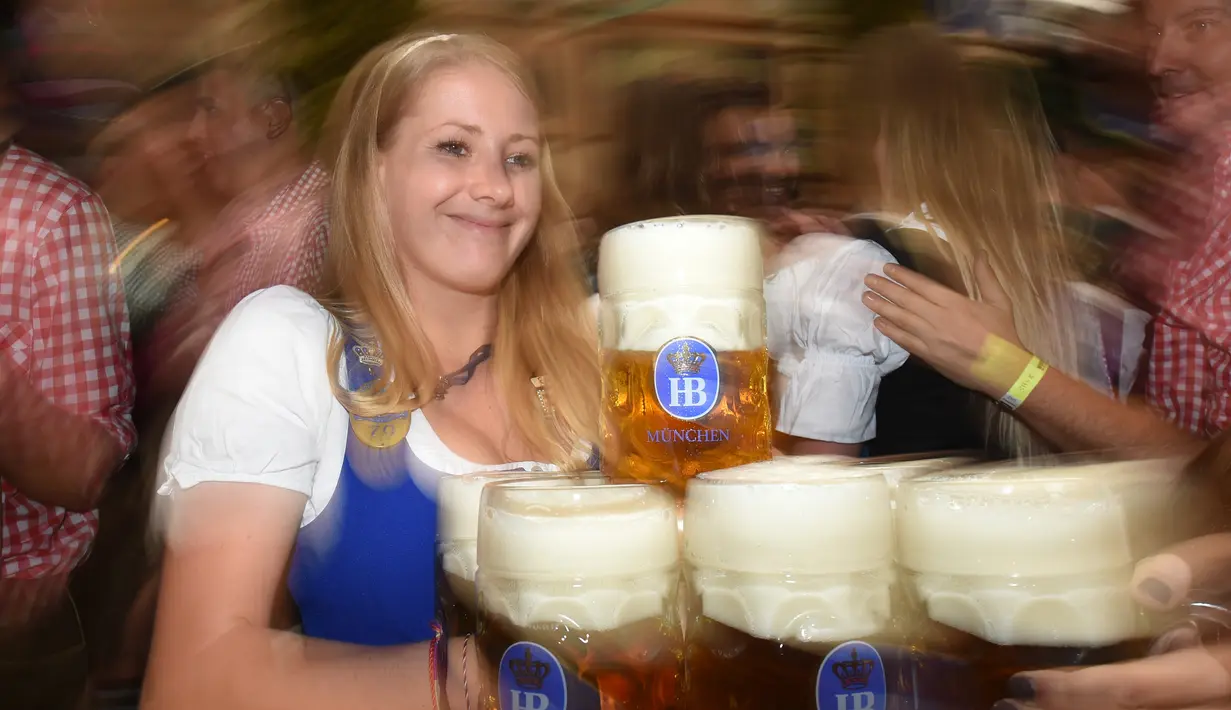 Pelayan membawa bir saat pembukaan festival bir terbesar di dunia Oktoberfest ke-185 di Munich, Jerman, Sabtu (22/9). (Christof STACHE/AFP)