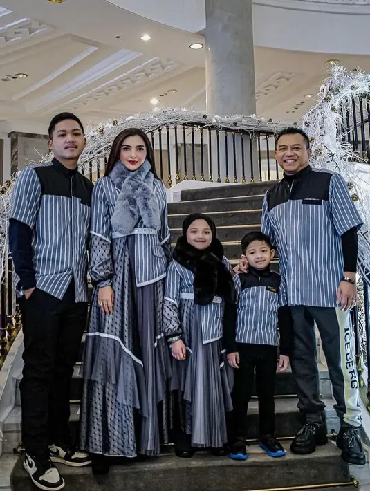 Berpose bersama anak-anak dan suaminya, Ashanty tampil glamor dengan gaun panjang warna biru dan syal bulu warna senada. (Instagram/ashanty_ash).