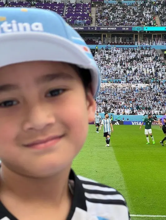 Senyum manis tetap terlihat dari wajahnya, mendukung tim kesayangannya. [Foto: instagram.com/raffinagita1717]