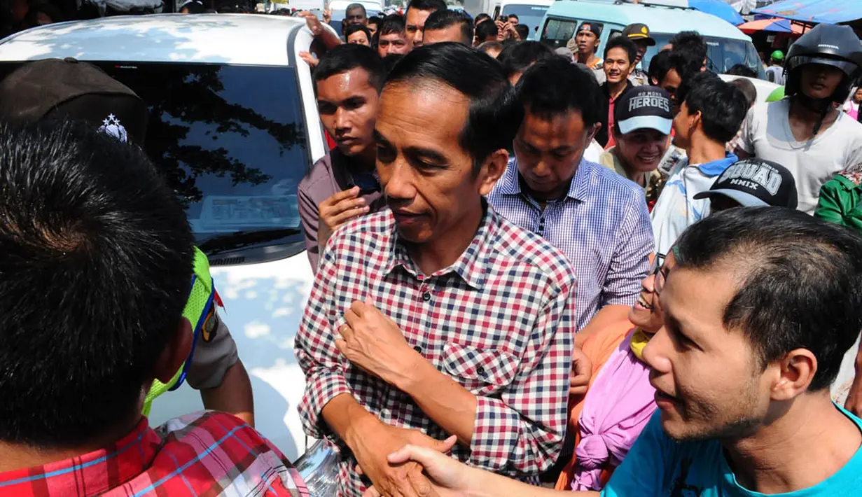 Kedatangan Jokowi disambut para warga dan pedagang yang ingin bersalaman dengan capres nomor urut dua tersebut, Jakarta, Senin (30/6/14). (Liputan6.com/Andrian M Tunay)