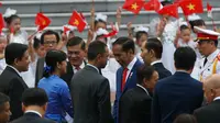 Presiden Jokowi bersalaman dengan para pejabat Vietnam dalam upacara penyambutan di Istana Kepresidenan, Hanoi, Vietnam (11/9). (AFP Photo/Pool/Kham)