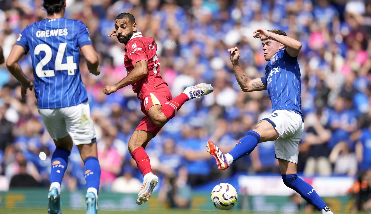 Striker Liverpool, Mohamed Salah (tengah) berebut bola dengan bek Ipswich Town, Leif Davis pada laga pekan pertama Premier League 2024/2025 di Portman Road Stadium, Ipswich, Sabtu (17/8/2024). (AP Photo/Alastair Grant)