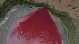 Foto dari udara yang diabadikan saat malam hari pada 30 Mei 2020 ini menunjukkan Danau Daghtu di Gurun Badain Jaran, Daerah Otonom Mongolia Dalam, China utara. Jauh di dalam Gurun Badain Jaran di Wilayah Alxa Right, terdapat sebuah danau berwarna merah muda yang dinamai Daghtu. (Xinhua/Xu Qin)