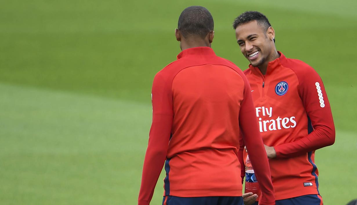 Pemain baru Paris Saint-Germain, Kylian Mbappe, berbincang dengan Neymar Jr, saat sesi latihan di Paris, Rabu (6/9/2017). Striker 18 tahun tersebut menjalani latihan perdananya bersama armada Les Parisiens. (AFP/Christophe Simon)