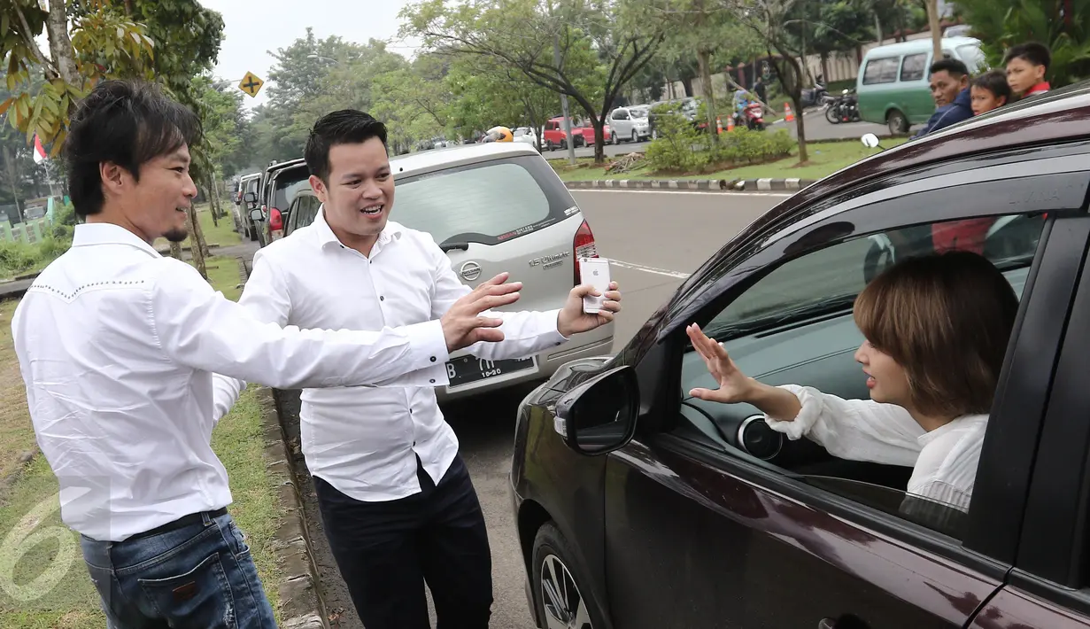 Mantan penyanyi duo T2, Tiwi, menyapa suaminya, Shogo Sakuramoto usai sidang perceraian mereka di Pengadilan Agama Tigaraksa, Tangerang, Rabu (22/3). Sidang keempat ini mengagendakan jawaban dari pihak Tiwi selaku penggugat. (Liputan6.com/Herman Zakharia)