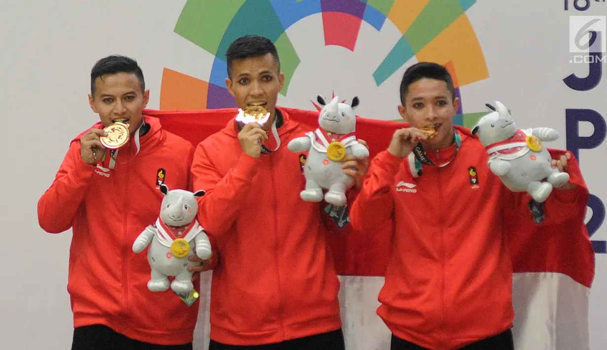 Nunu Nugraha, Asep Yuldan Sani, dan Anggi Faisal Mubarok menunjukkan medali emas pencak silat beregu putra Asian Games 2018 di TMII, Jakarta, Senin (27/8). Pencak silat beregu putra menyumbang emas ke-15 untuk Indonesia. (Merdeka.com/Arie Basuki)