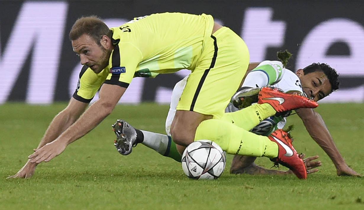 Striker Gent, Laurent Depoitre, terjatuh saat berebut bola dengan gelandang Wolfsburg, Luiz Gustavo. Tetapi daya serang Wolfsburg lebih efisien terbukti mereka unggul 3-0 terlebih dahulu. (AFP/John Thys)