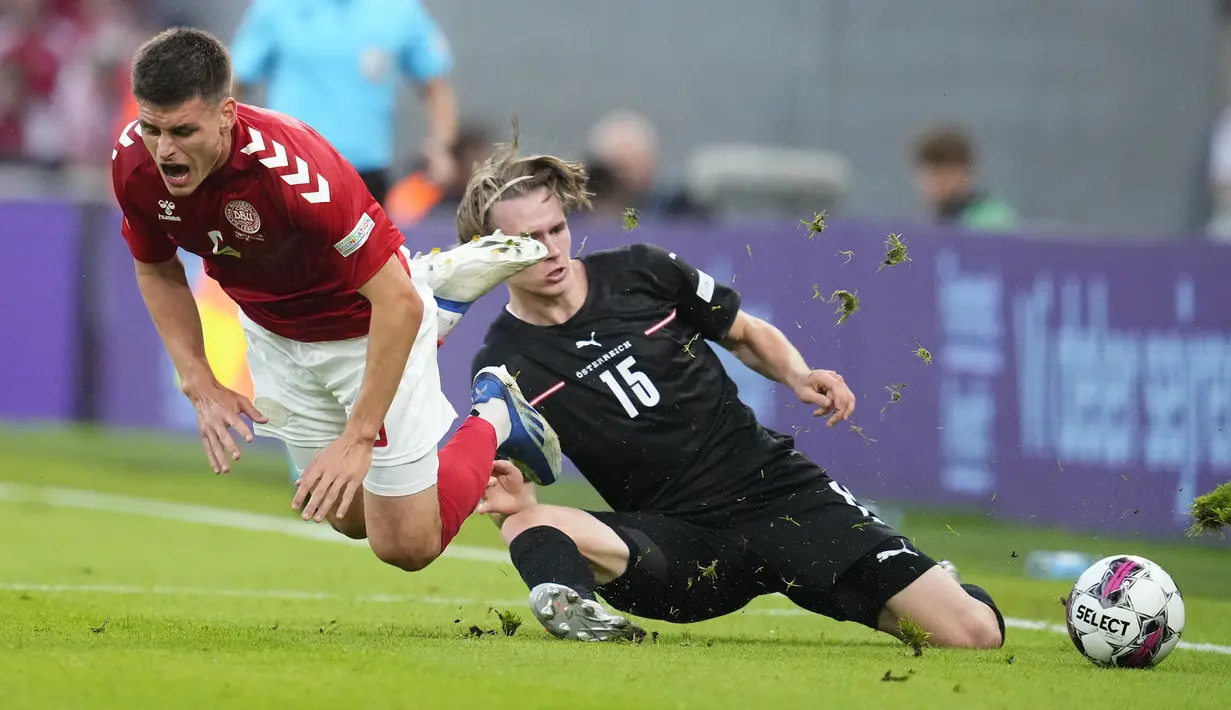 <p>Bek Denmark, Joakim Maehle dilanggar pemain Austria, Patrick Wimmer pada laga keempat Grup A1 UEFA Nations League 2022/2023 di Parken Stadium, di Kopenhagen, Selasa (14/6/2022). Denmark menang atas Austria dengan skor 2-0. (Claus Bech/Ritzau Scanpix via AP)</p>