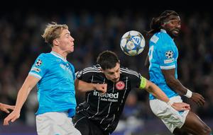 Pemain Frankfurt Robin Koch (tengah) dan pemain Napoli Rasmus Hojlund (kiri) berebut bola pada pertandingan fase&nbsp;liga Liga Champions di Naples, Rabu,&nbsp;5 November 2025. (AP Photo/Gregorio Borgia)