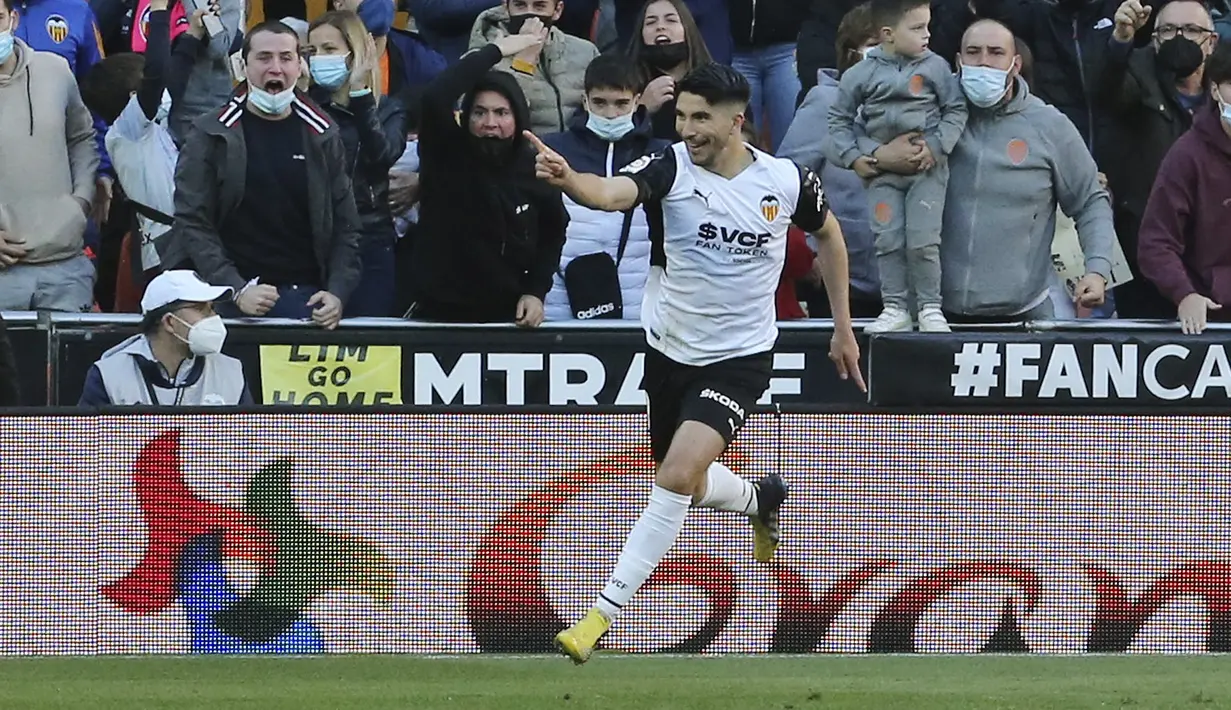 Gelandang Valencia, Carlos Soler berselebrasi usai mencetak gol ke gawang Barcelona pada pertandingan La Liga Spanyol di stadion Mestalla, Spanyol, Minggu (20/2/2022). Barcelona menang atas Valencia 4-2. (AP Photo/Alberto Saiz)