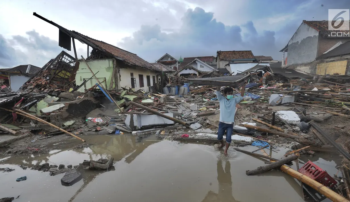 Warga mengumpulkan perkakas dari bangunan rumahnya yang rusak akibat terjangan tsunami di Kampung Sumur Pesisir, Pandeglang, Banten, Senin (24/12). Pascatsunami Selat Sunda, warga pulang untuk mencari  barang berharga miliknya. (Merdeka.com/Arie Basuki)