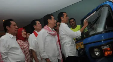 Minggu (1/6/14), Jokowi menandatangani Bajaj yang mengantarnya pada saat mengambil nomor urut di Kantor KPU. (Liputan6.com/Herman Zakharia)