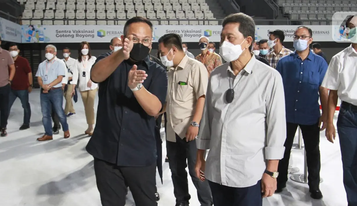 Ketum Perbanas sekaligus Wamen BUMN II Kartika Wirjoatmodjo dan Kepala Eksekutif Pengawas Perbankan OJK Heru Kristiyana berbincang pada kunjungan Sentra Vaksinasi Gotong Royong Perbanas di Lapangan Tenis Indoor Senayan, Jakarta, Sabtu (19/6/2021). (Liputan6.com/HO/Rizky)