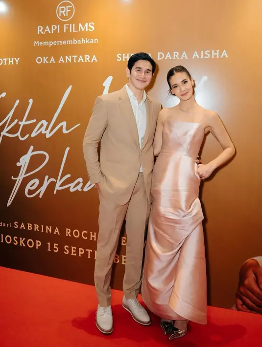 Keduanya tampil kompak mengenakan busana nuansa warna soft.