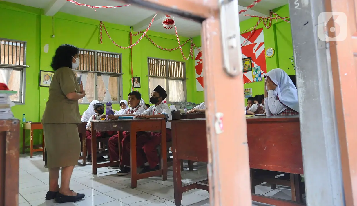 Siswa mengerjakan ujian penilaian akhir semester (PAS) yang dihadiri guru pengawas di SDN Pondok Cina 1 Depok, Jawa Barat, Senin (5/12/2022). Guru SDN Pondokcina 1 Depok kembali hadir di sekolah itu pada hari ini. (merdeka.com/Arie Basuki)