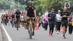 Sejumlah warga berolahraga saat Hari Bebas Kendaraan Bermotor (HBKB) di Bundaran Hotel Indonesia (HI), Jakarta, Minggu (29/12/2024). (Liputan6.com/Herman Zakharia)