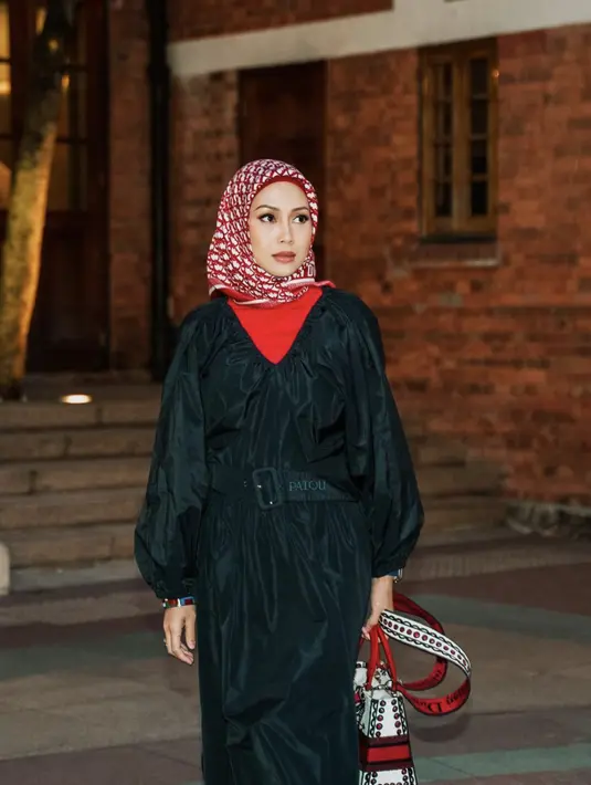<p>Merah dan hitam tak pernah gagal menjadi nuansa kontras klasik yang penuh gaya. Kesan stylish semakin terlihat dari kerudung yang dikenakannya. [Foto: Instagram/ azrinazmazharhakim]</p>
