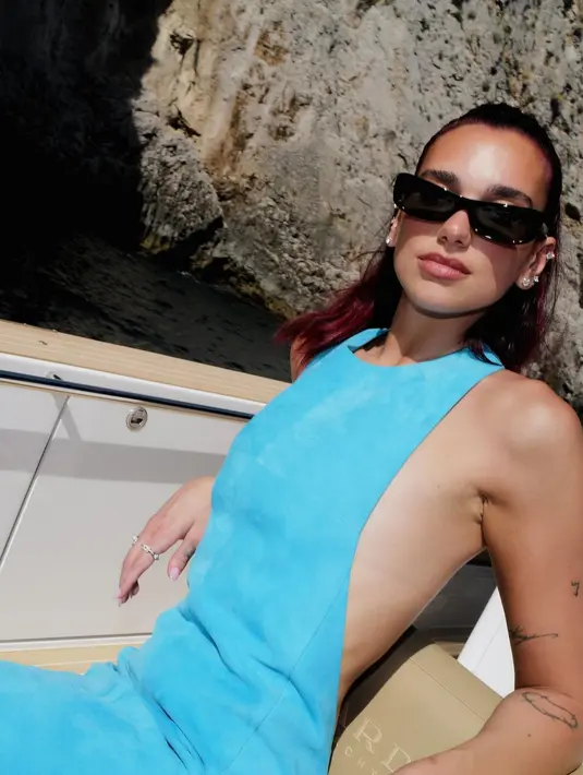 Dua Lipa hadir sebagai tamu undangan dengan low backless dress berwarna biru terang [@dualipa]