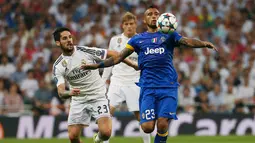 Gelandang Juventus, Arturo Vidal (kanan) mengontrol bola dari kejaran gelandang Real Madrid, Isco saat leg kedua semifinal Liga Champions di Stadion Santiago Bernabeu, Kamis (14/5/2015). Real Madrid bermain imbang 1-1 atas Juventus. (Reuters/Sergio Perez)