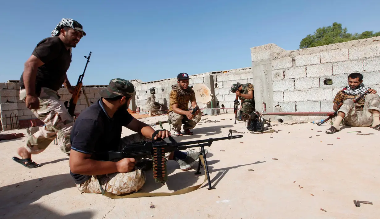 Pasukan militer pemerintah Libya mempersiapkan sejumlah senjata api saat melakukan serangan kepada para pejuang ISIS dari atap atap rumah di daerah Zaafran, di Sirte, Libya, 30 Juni 2016. (REUTERS/Ismail Zitouni)
