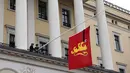 Bendera kerajaan yang dihiasi pita hitam dikibarkan setengah tiang oleh anggota Pasukan Pengawal Kerajaan dari balkon istana setelah Raja Harald V dari Norwegia wafat di Oslo, Norwegia, Jumat, 28 Agustus 2026. (AFP/ Odd Andersen)