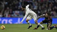 Gelandang Real Madrid, Isco, ditarik kakinya oleh striker Valencia, Santi Mina, pada laga La Liga di Stadion Santiago Bernabeu, Madrid, Sabtu (1/12). Madrid menang 2-0 atas Valencia. (AFP/Oscar Del Pozo)
